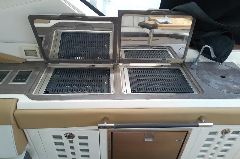 Slide: The Image of Outdoor kitchen on a 2019 Sea Ray SLX 400 Outboard boat with dual grills and sink. - 20