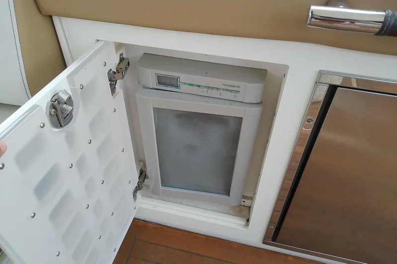 Slide: The Image of Built-in refrigerator on 2019 Sea Ray SLX 400 Outboard boat, open compartment view. - 23