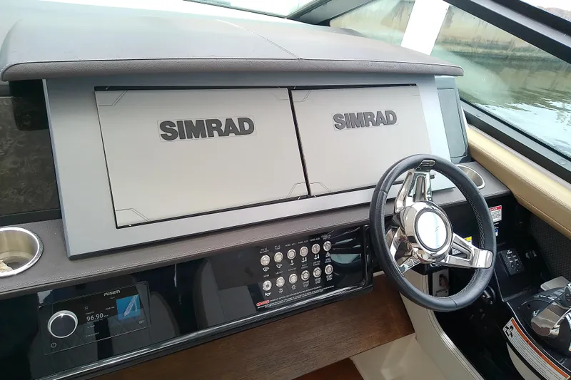 Slide: The Image of 2019 Sea Ray SLX 400 Outboard helm with Simrad displays and modern steering wheel. - 27