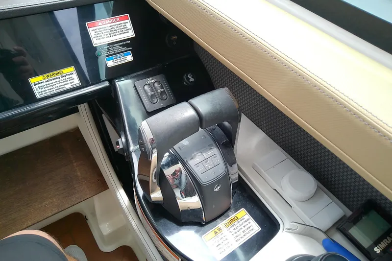 Slide: The Image of Control panel of a 2019 Sea Ray SLX 400 Outboard boat with throttle levers. - 28
