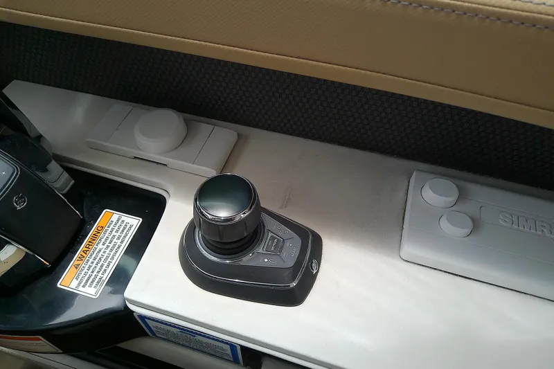 Slide: The Image of Control panel of a 2019 Sea Ray SLX 400 Outboard boat with joystick and warning label. - 29