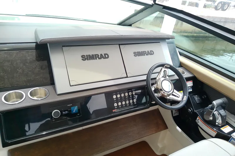 Slide: The Image of 2019 Sea Ray SLX 400 Outboard helm with Simrad displays and modern controls. - 30