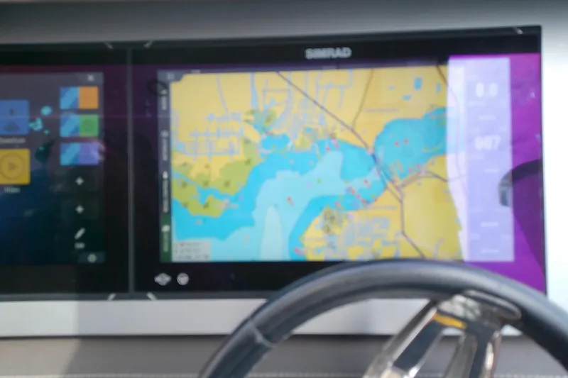 Slide: The Image of Simrad navigation display on 2019 Sea Ray SLX 400 Outboard boat dashboard. - 31