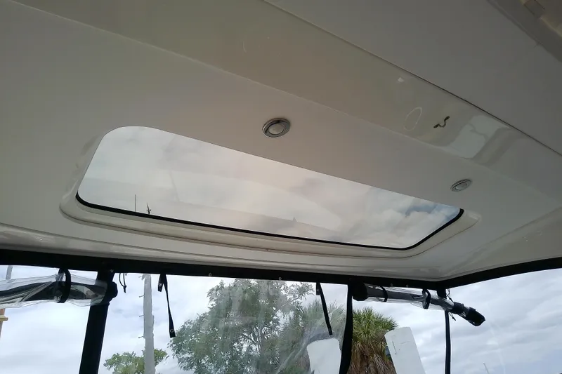 Slide: The Image of 2019 Sea Ray SLX 400 Outboard sunroof view with cloudy sky background. - 34