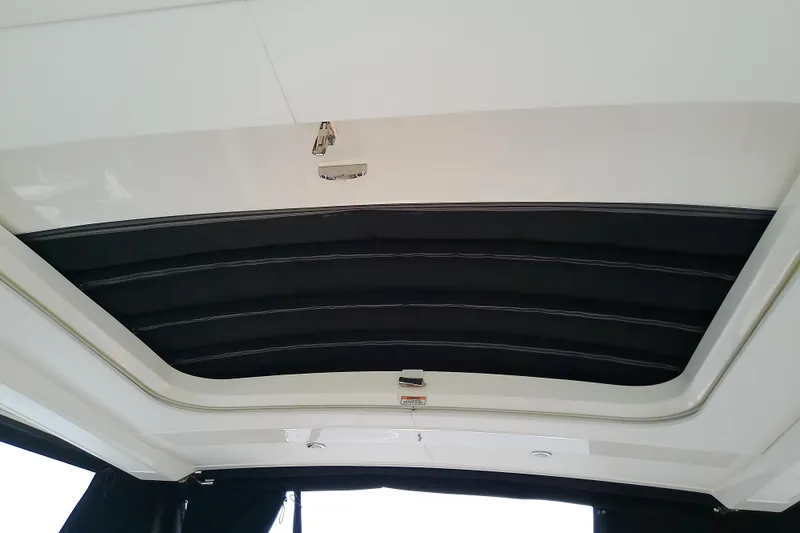 Slide: The Image of 2019 Sea Ray SLX 400 Outboard retractable roof detail, showcasing sleek design and functionality. - 36