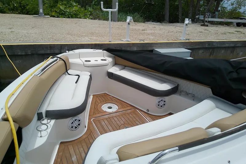 Slide: The Image of 2019 Sea Ray SLX 400 Outboard boat interior with cushioned seating and wood flooring. - 37