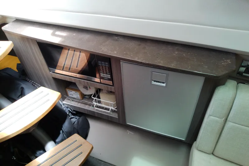 Slide: The Image of Interior of 2019 Sea Ray SLX 400 Outboard with microwave and storage cabinet. - 43