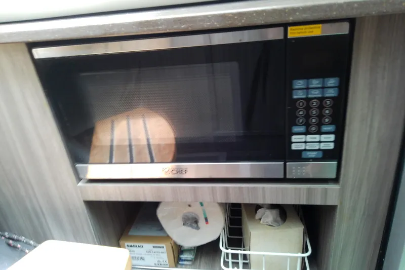 Slide: The Image of Microwave oven in 2019 Sea Ray SLX 400 Outboard boat interior kitchen setup. - 44