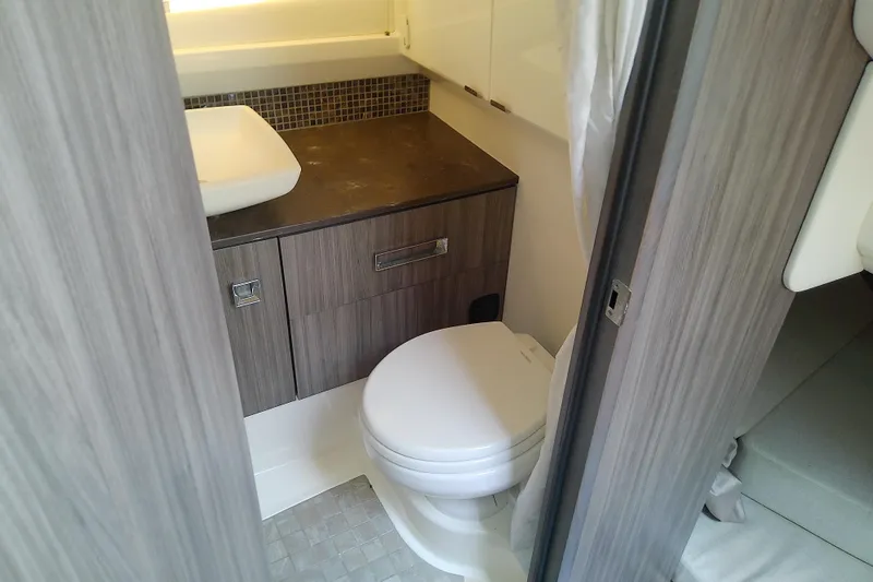 Slide: The Image of 2019 Sea Ray SLX 400 Outboard bathroom with modern sink and toilet. - 46