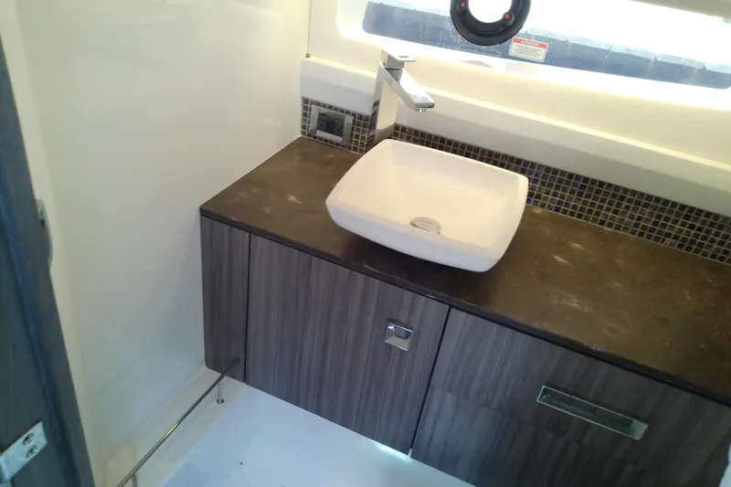 Slide: The Image of Luxurious bathroom interior of 2019 Sea Ray SLX 400 Outboard with modern sink and cabinetry. - 47