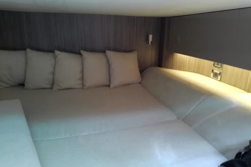 Slide: The Image of Luxurious cabin interior of 2019 Sea Ray SLX 400 Outboard with plush seating and ambient lighting. - 48