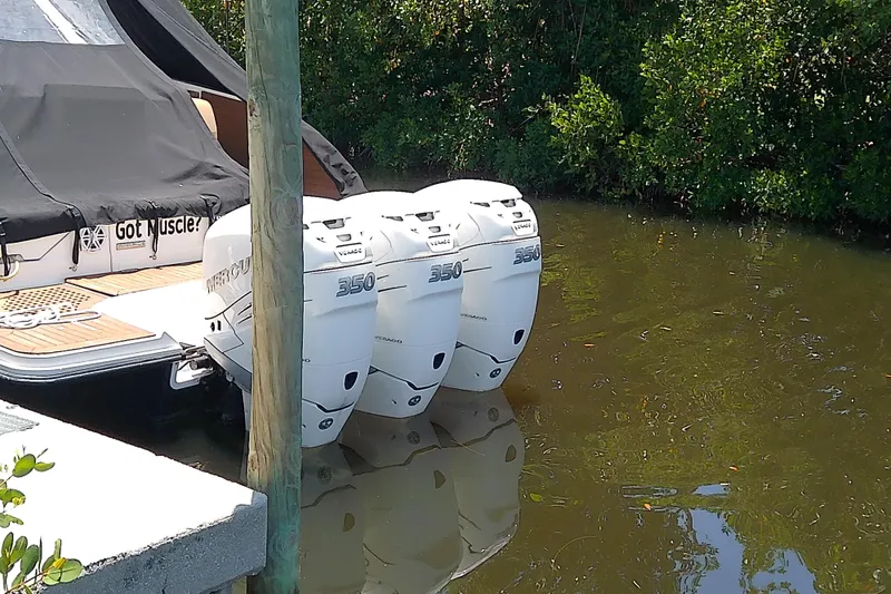 Slide: The Image of 2019 Sea Ray SLX 400 Outboard with triple Mercury 350 engines docked in water. - 5