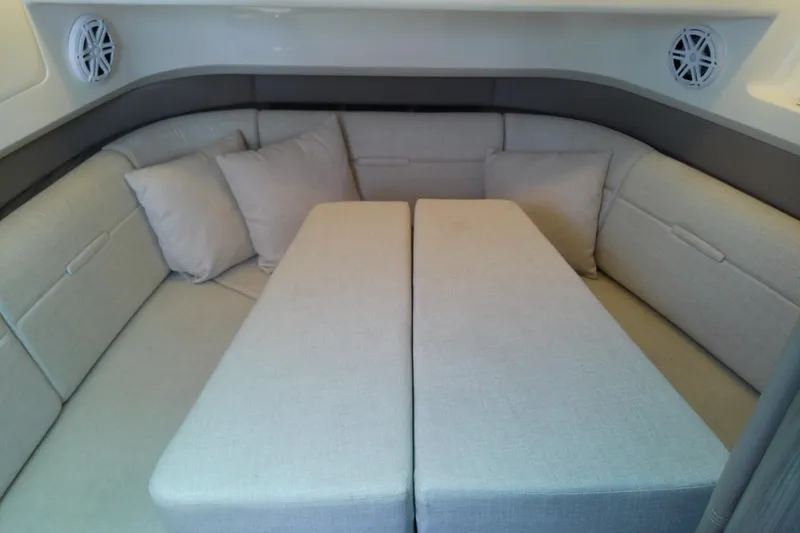 Slide: The Image of Luxurious interior seating of 2019 Sea Ray SLX 400 Outboard boat with plush cushions. - 50