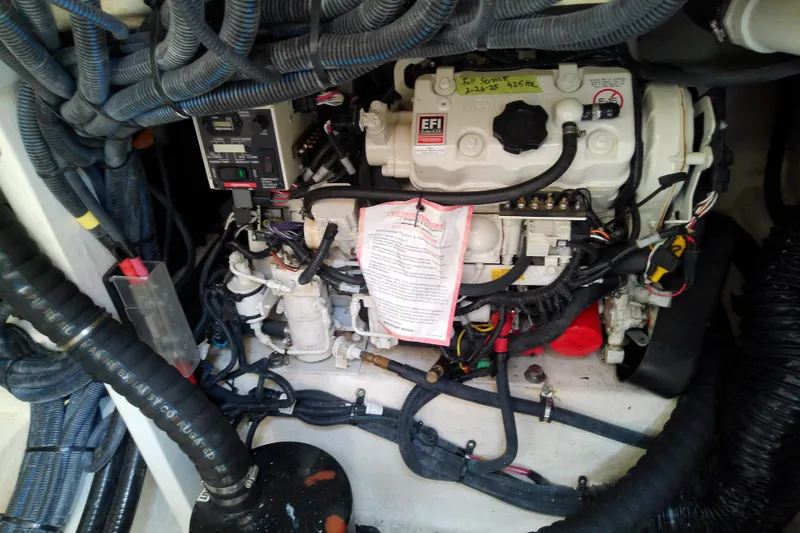 Slide: The Image of Engine compartment of a 2019 Sea Ray SLX 400 Outboard with visible wiring and components. - 52