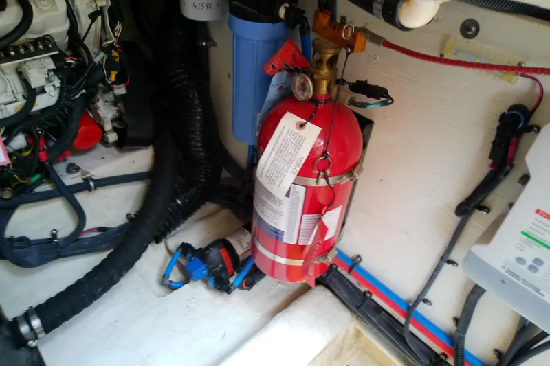 Slide: The Image of Engine room of 2019 Sea Ray SLX 400 Outboard with fire extinguisher and wiring. - 54