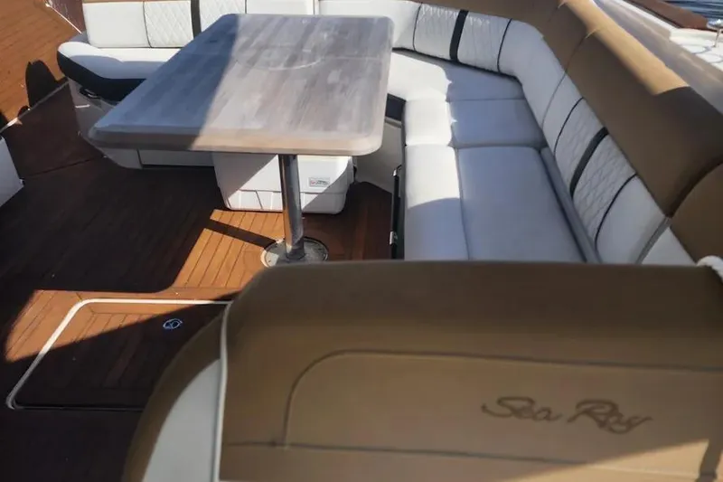 Slide: The Image of Luxurious seating area on 2019 Sea Ray SLX 400 Outboard with elegant wood table. - 6