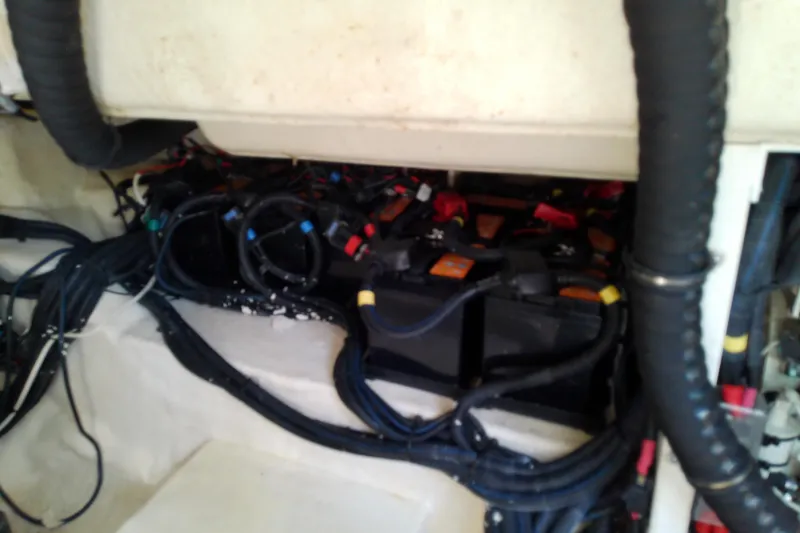 Slide: The Image of 2019 Sea Ray SLX 400 Outboard battery compartment with cables and wiring. - 58