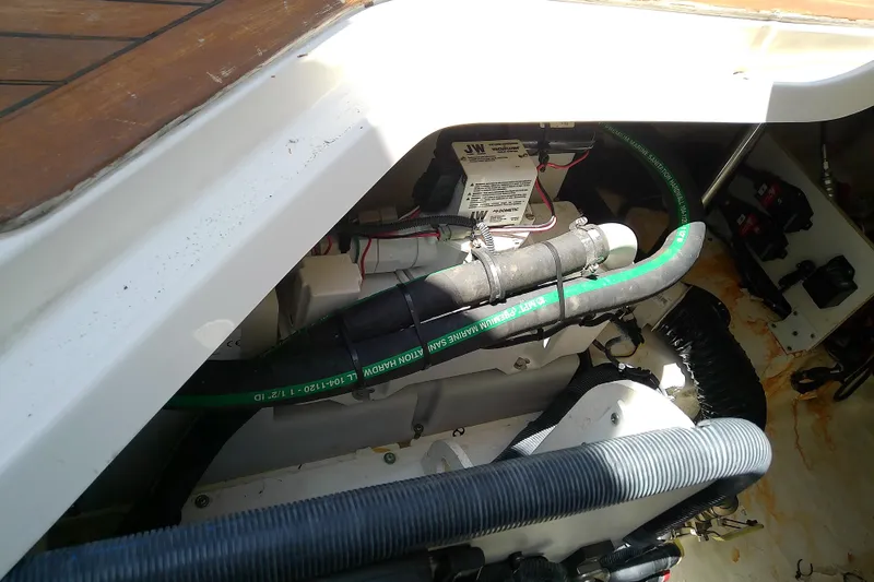 Slide: The Image of Engine compartment of a 2019 Sea Ray SLX 400 Outboard, showcasing hoses and wiring. - 54