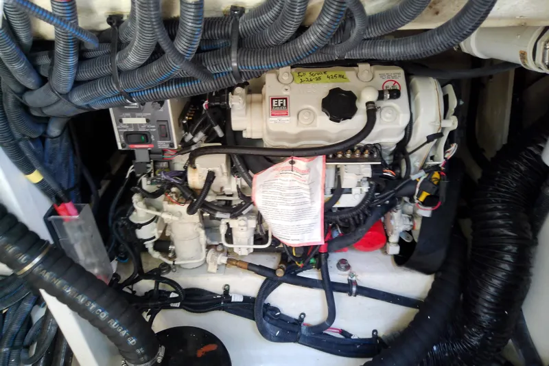 Slide: The Image of Engine compartment of a 2019 Sea Ray SLX 400 Outboard with visible wiring and components. - 56