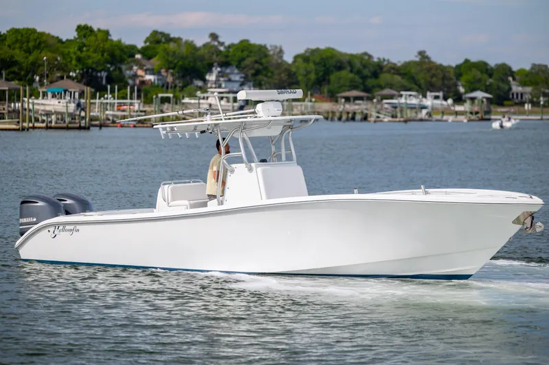 The Image of 2013 Yellowfin 32 Offshore boat cruising on a calm waterway. - 0