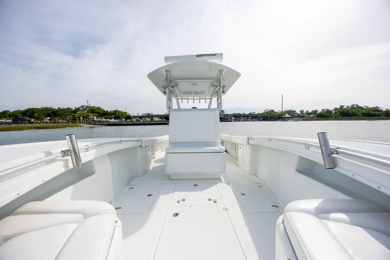 Slide: The Image of 2013 Yellowfin 32 Offshore boat interior with seating, on calm water. - 14