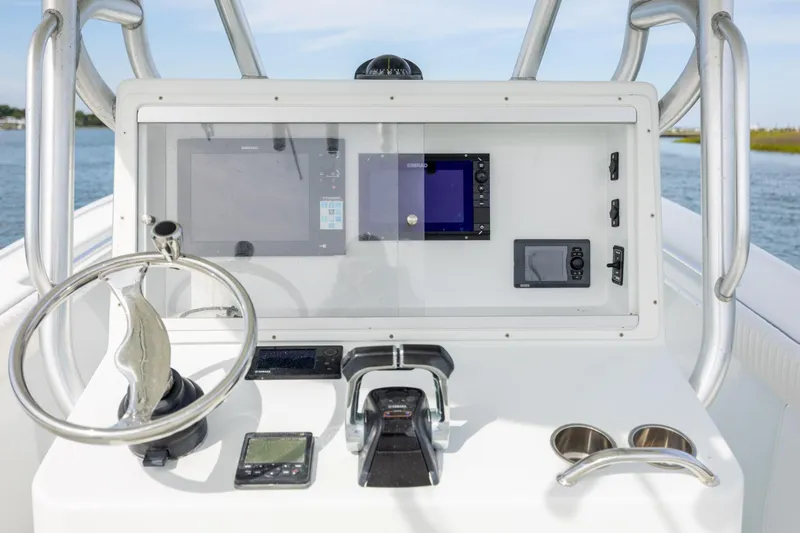 Slide: The Image of 2013 Yellowfin 32 Offshore boat dashboard with steering wheel and navigation equipment. - 17