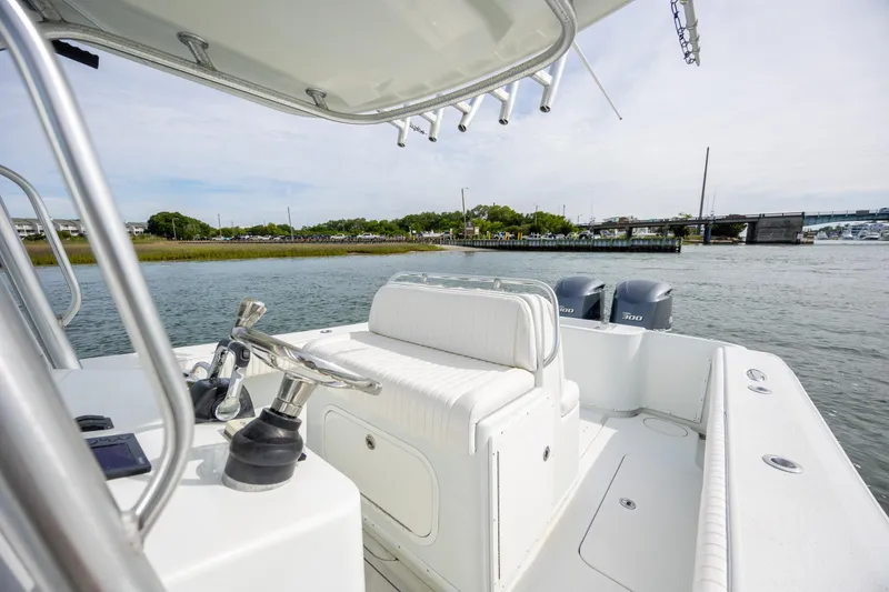Slide: The Image of 2013 Yellowfin 32 Offshore boat on water, featuring dual engines and sleek design. - 18