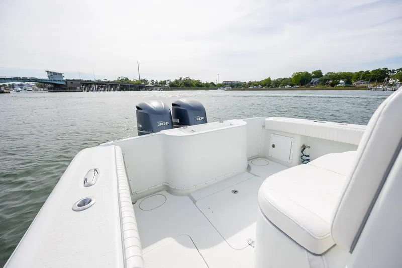 Slide: The Image of 2013 Yellowfin 32 Offshore boat with dual engines on calm water. - 19