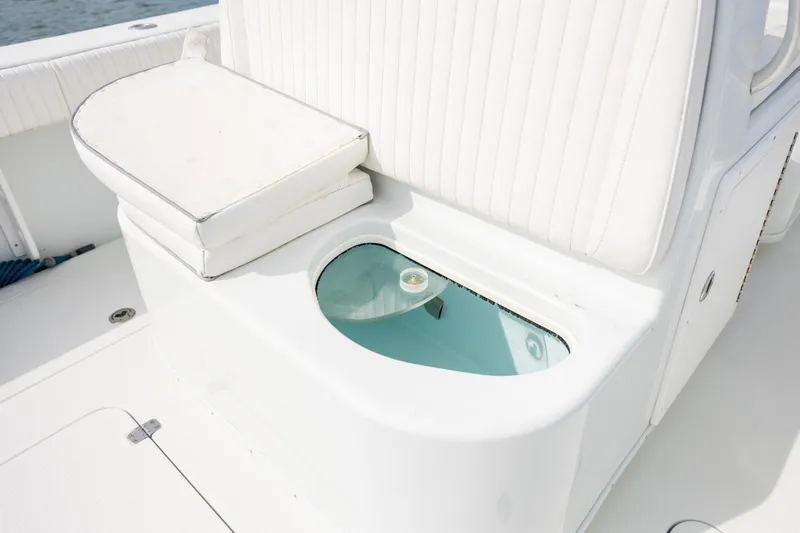 Slide: The Image of 2013 Yellowfin 32 Offshore boat with cushioned seating and built-in storage compartment. - 20