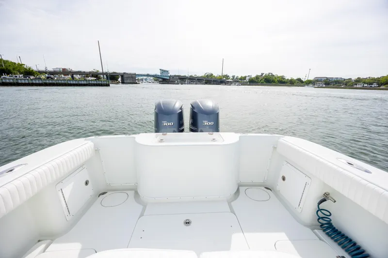 Slide: The Image of 2013 Yellowfin 32 Offshore boat with twin 300 horsepower engines on calm water. - 26