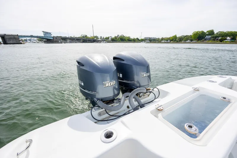Slide: The Image of 2013 Yellowfin 32 Offshore boat with twin Yamaha 300 engines on a calm waterway. - 28