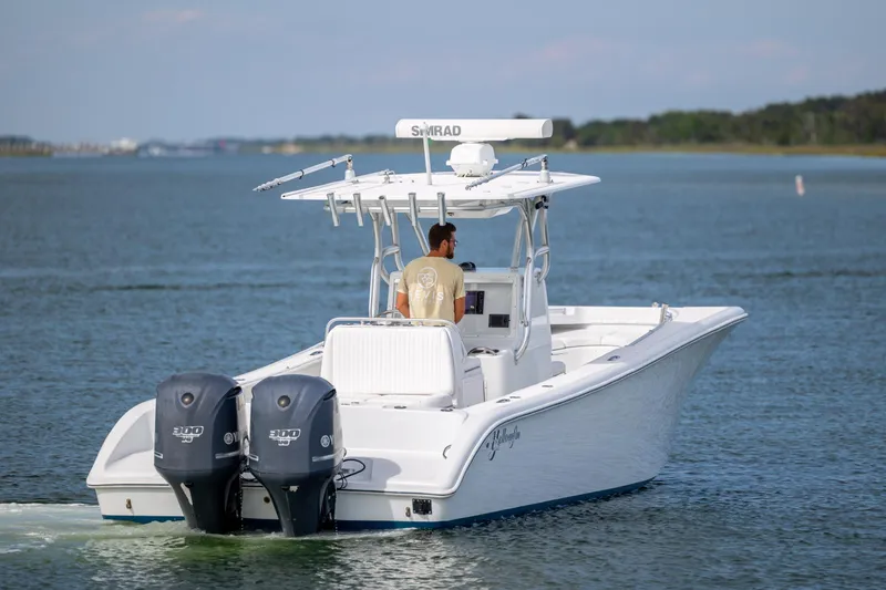 Slide: The Image of 2013 Yellowfin 32 Offshore boat cruising on calm waters with dual engines. - 3