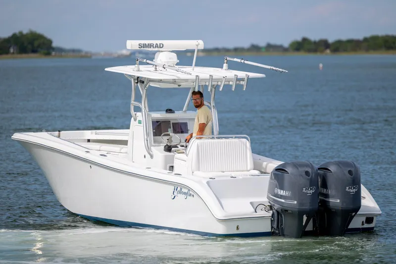 Slide: The Image of 2013 Yellowfin 32 Offshore boat with dual Yamaha engines on calm water. - 5