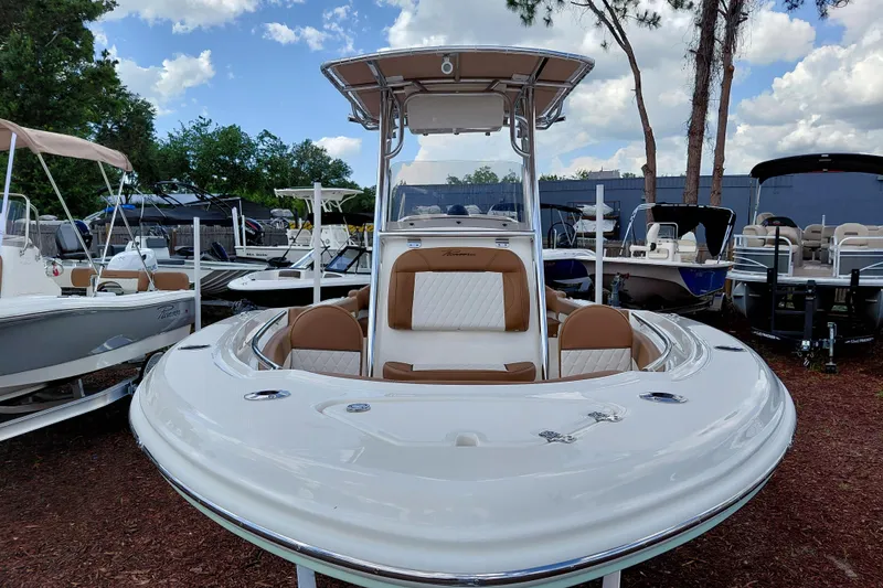 Slide: The Image of 2026 Pioneer 202 Islander boat with sleek design, displayed outdoors under a blue sky. - 10