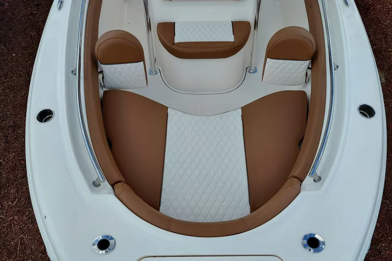 Slide: The Image of 2026 Pioneer 202 Islander boat interior with brown and white cushioned seating. - 11