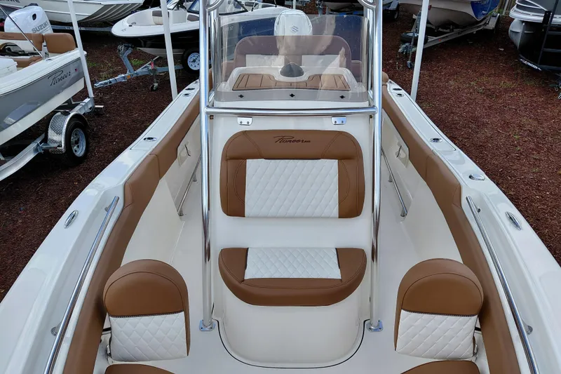 Slide: The Image of 2026 Pioneer 202 Islander boat interior with brown and white seating, showcasing luxury design. - 12