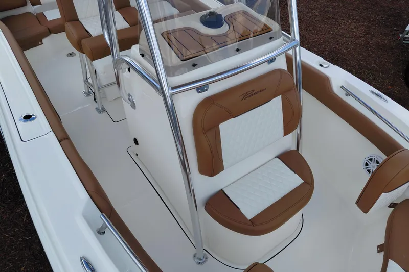 Slide: The Image of 2026 Pioneer 202 Islander boat interior with brown and white seating, chrome accents. - 13