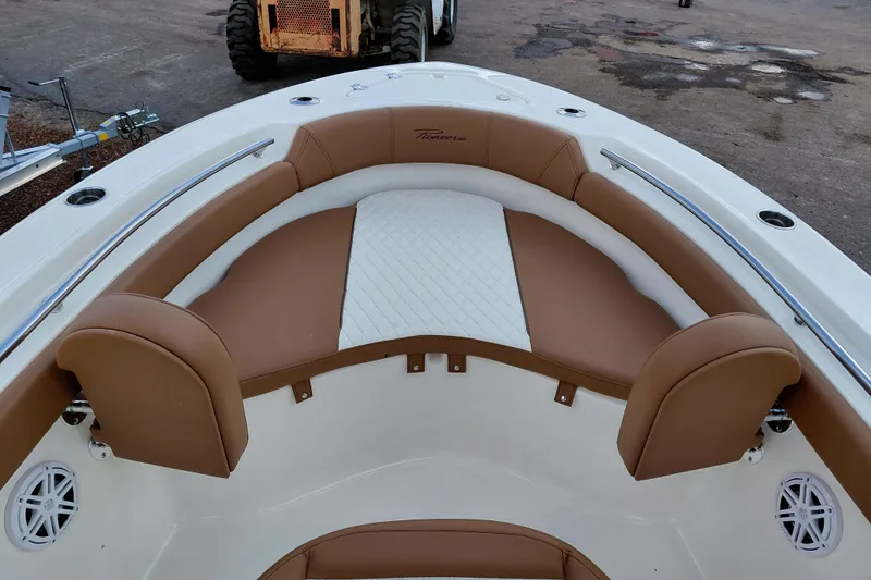Slide: The Image of 2026 Pioneer 202 Islander boat interior with tan and white seating, featuring stainless steel rails. - 16
