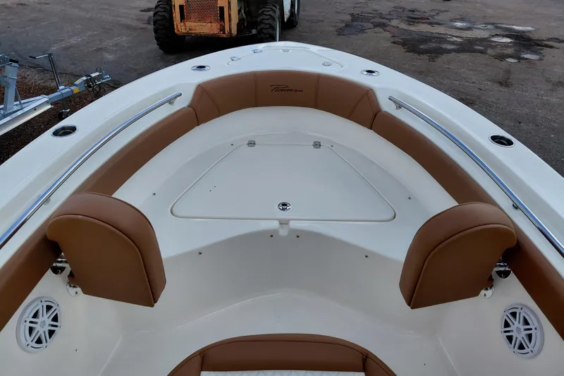 Slide: The Image of 2026 Pioneer 202 Islander boat interior with tan seating and white deck. - 17
