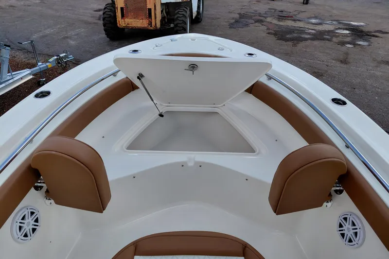 Slide: The Image of 2026 Pioneer 202 Islander boat interior with open storage compartment and brown seating. - 18