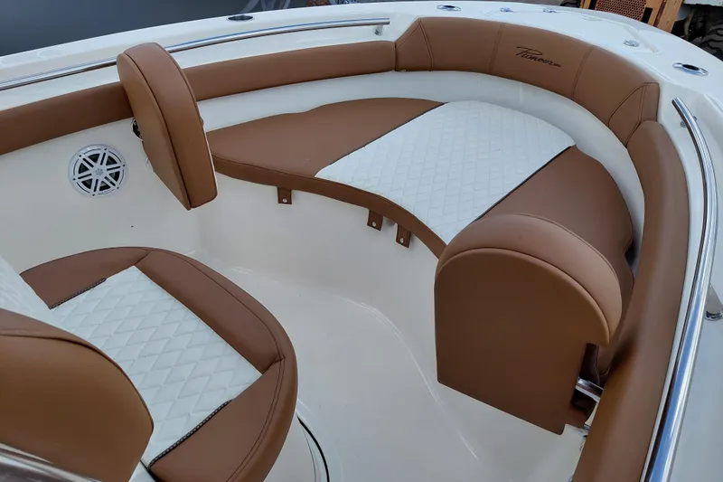 Slide: The Image of Luxurious seating on 2026 Pioneer 202 Islander boat with brown and white upholstery. - 19