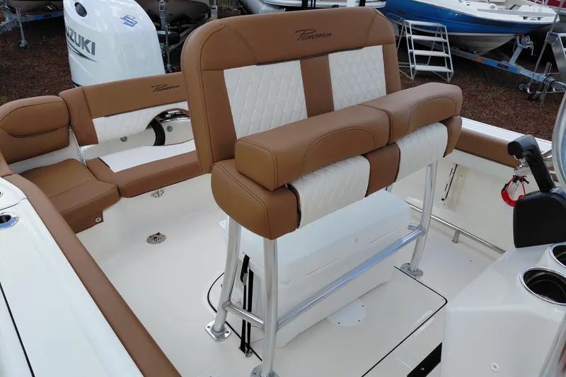 Slide: The Image of 2026 Pioneer 202 Islander boat interior with tan and white seating, showcasing modern design. - 26