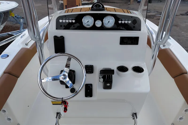 Slide: The Image of 2026 Pioneer 202 Islander boat console with steering wheel, gauges, and controls. - 27