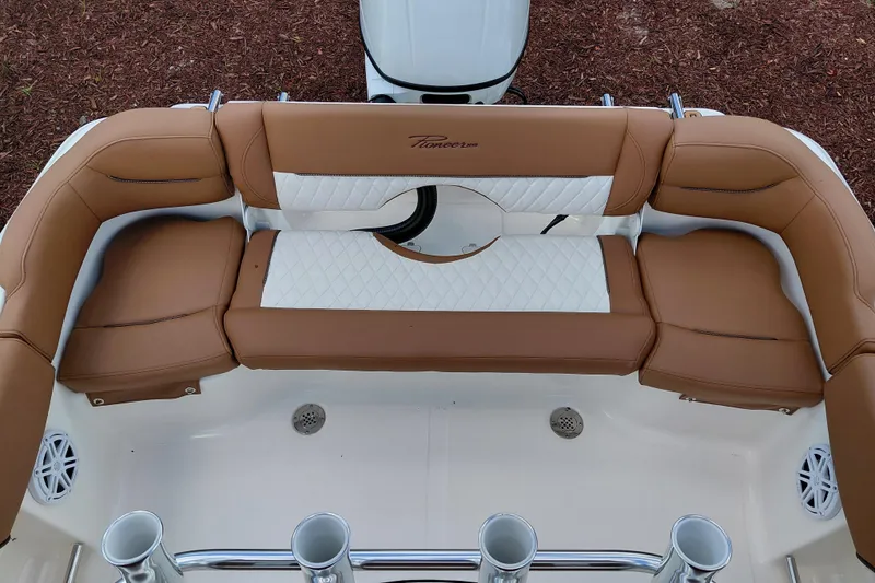 Slide: The Image of 2026 Pioneer 202 Islander boat interior with brown and white cushioned seating. - 30
