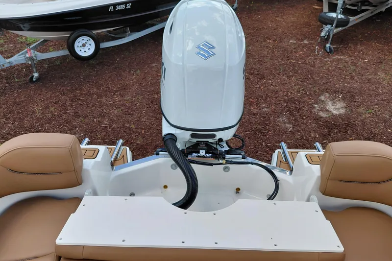 Slide: The Image of 2026 Pioneer 202 Islander boat with Suzuki outboard motor, featuring tan seating and white deck. - 33
