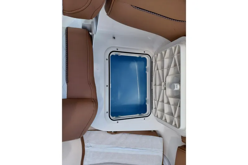 Slide: The Image of Open storage compartment on 2026 Pioneer 202 Islander boat with brown seating. - 35