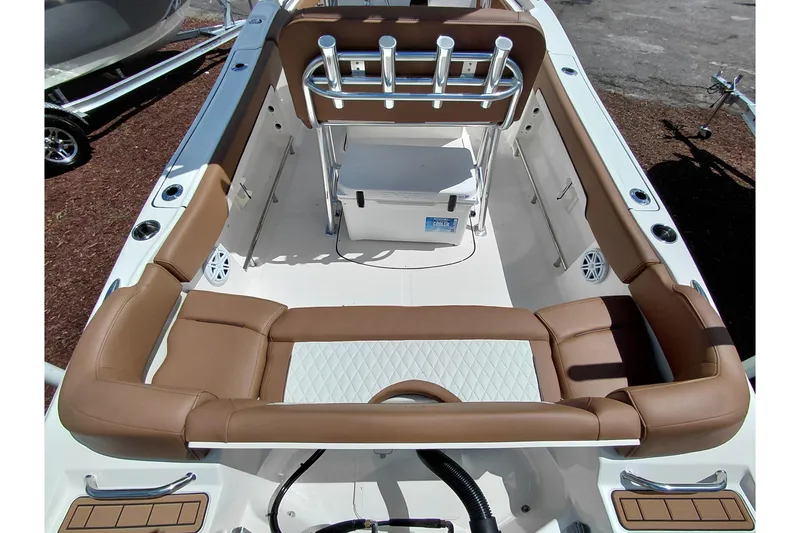 Slide: The Image of 2026 Pioneer 202 Islander boat interior with tan seating and rod holders. - 38
