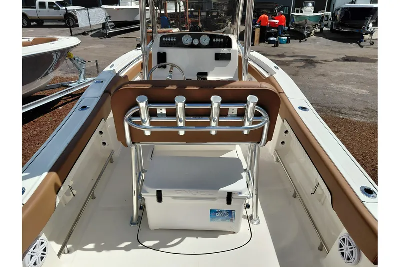 Slide: The Image of 2026 Pioneer 202 Islander boat interior with rod holders and cooler on deck. - 39