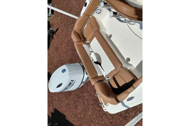Slide: The Image of 2026 Pioneer 202 Islander boat with tan seating and Suzuki outboard motor. - 43