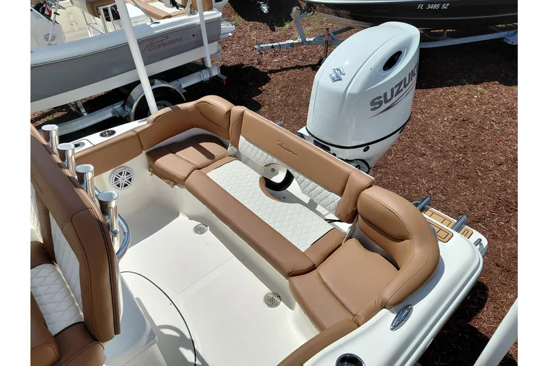 Slide: The Image of 2026 Pioneer 202 Islander boat interior with tan seating and Suzuki outboard motor. - 44